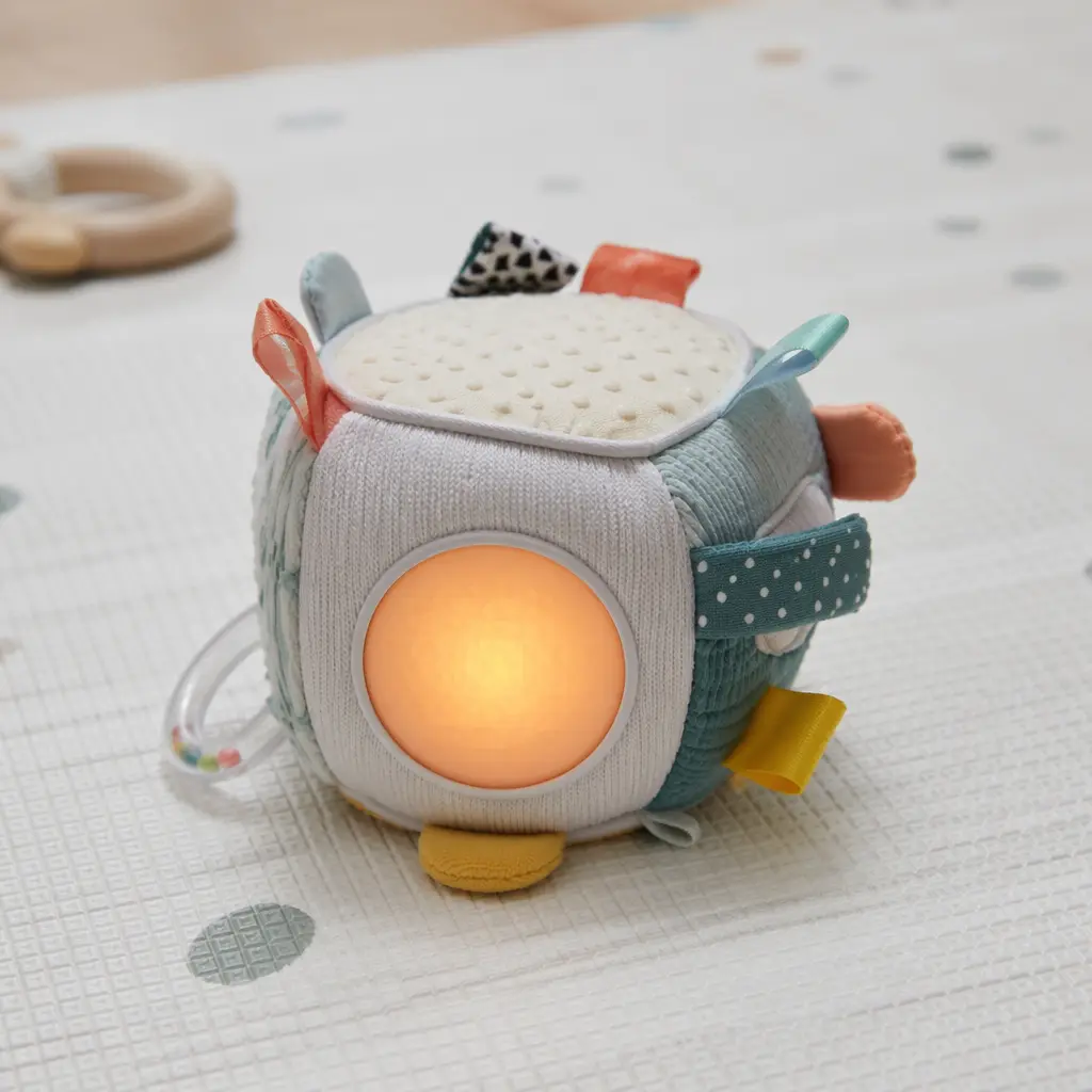 Close-up of a soft electronic sensory toy with gentle light