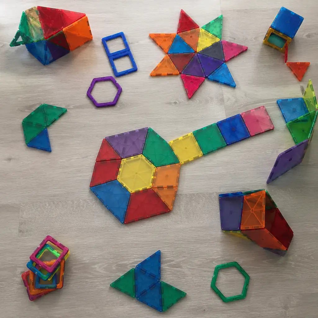Assorted open-ended building pieces arranged into abstract shapes