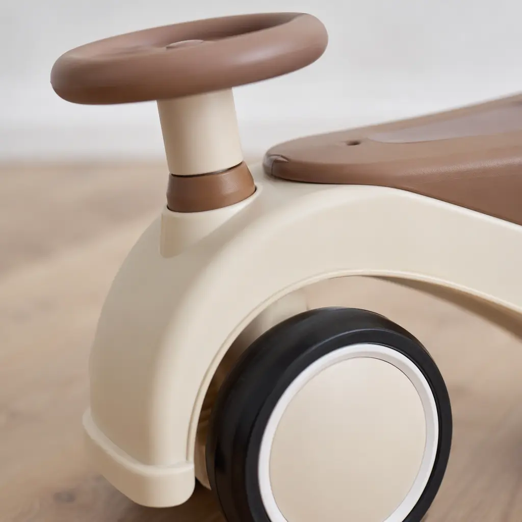 Close-up of a ride-on toy wheel and steering handle