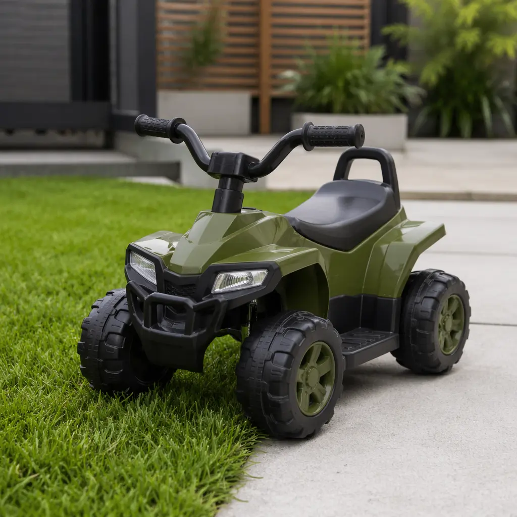 A children's ride-on toy positioned where grass meets pavement outdoors