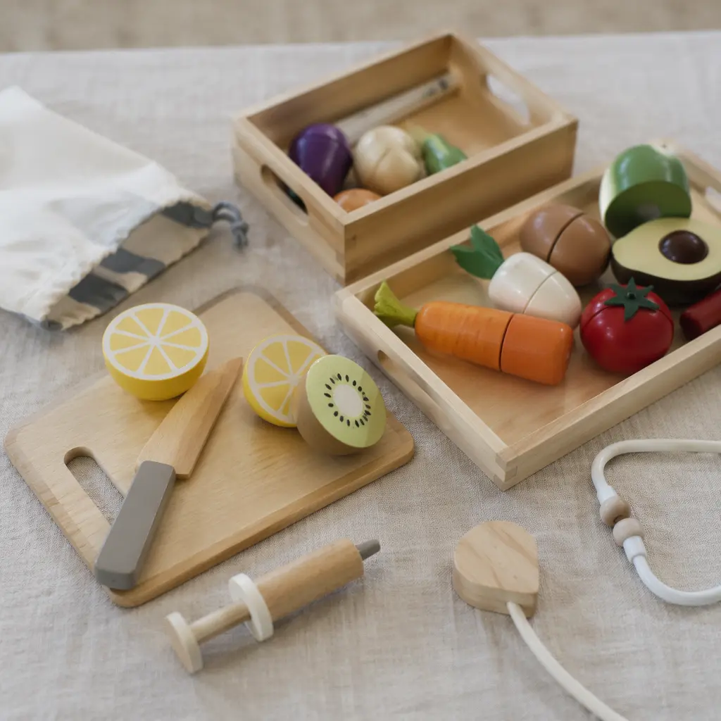 A tabletop scene showing pretend play pieces arranged for imaginative play.