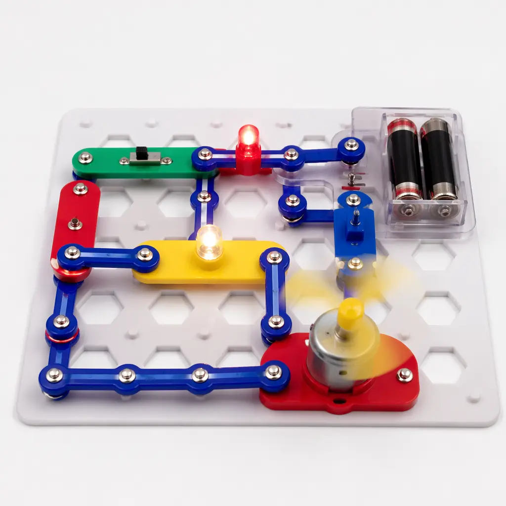 A click-together electronic building set assembled on a white base grid