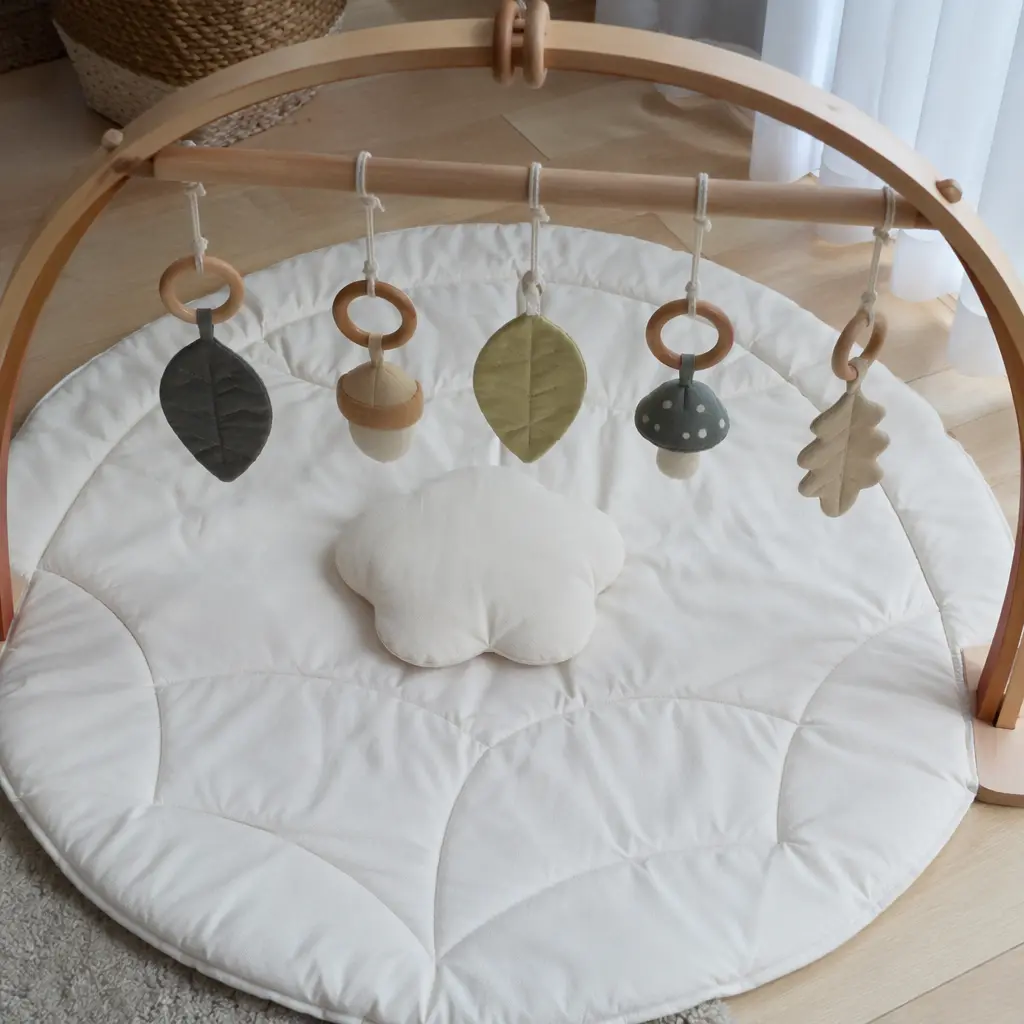 Simple hanging toys on a baby play mat designed for reaching