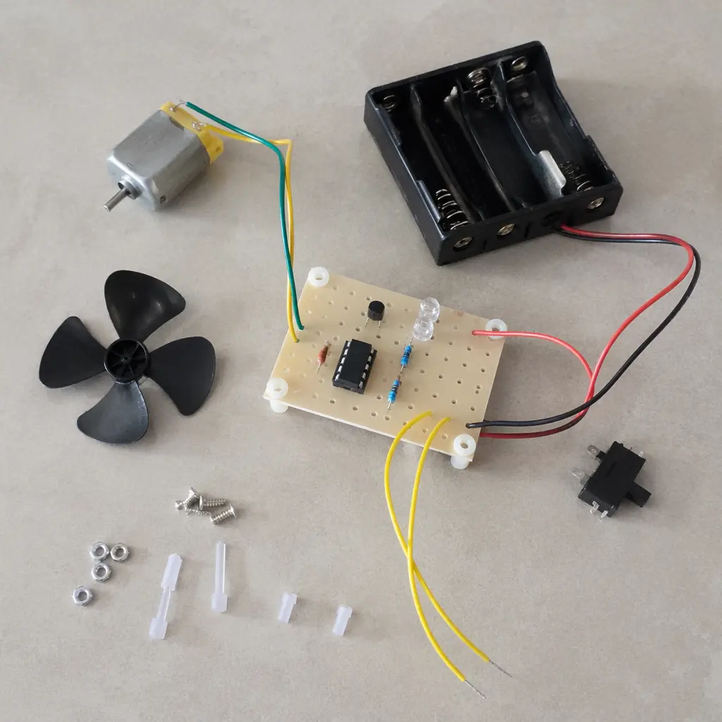 Partially assembled electronic kit with wires and a small motor