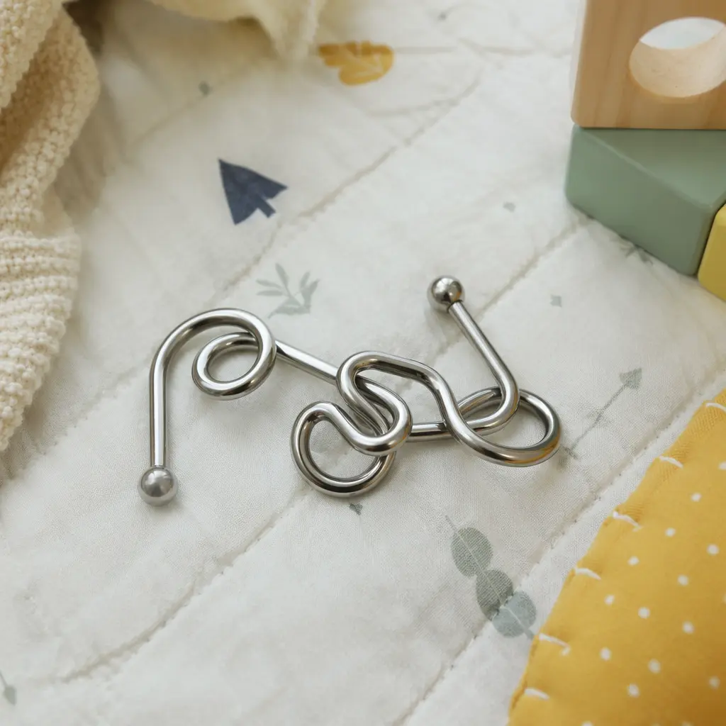 Metal disentanglement puzzle on a fabric play mat