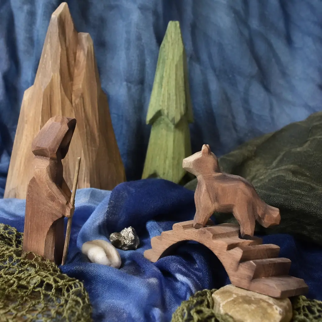Wooden figures and fabric props arranged as a fantasy storytelling scene