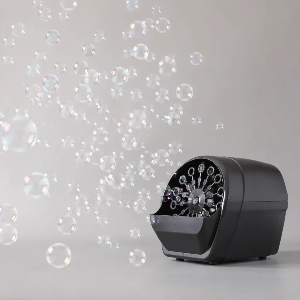 A compact bubble machine releasing streams of soap bubbles