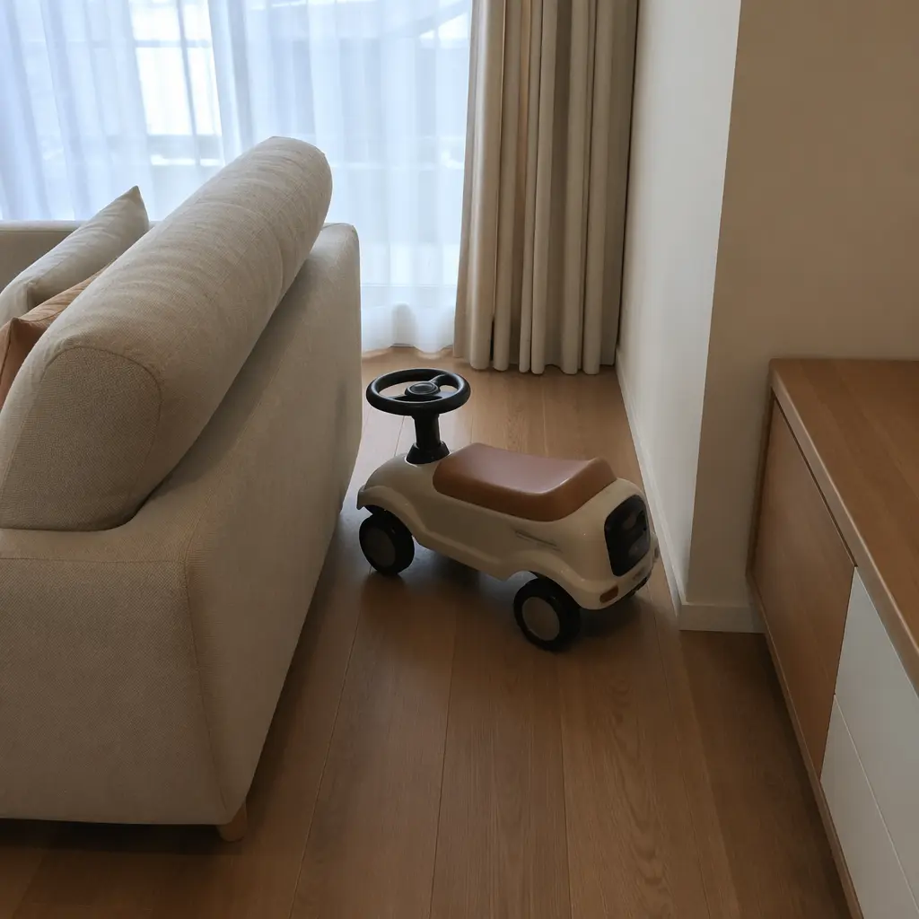 Small ride-on toy fitting beside furniture in a compact living room