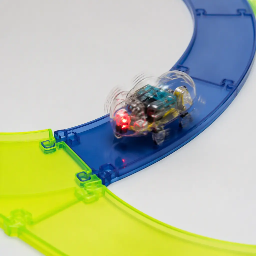 A small translucent bug-inspired robot toy moving through curved track pieces