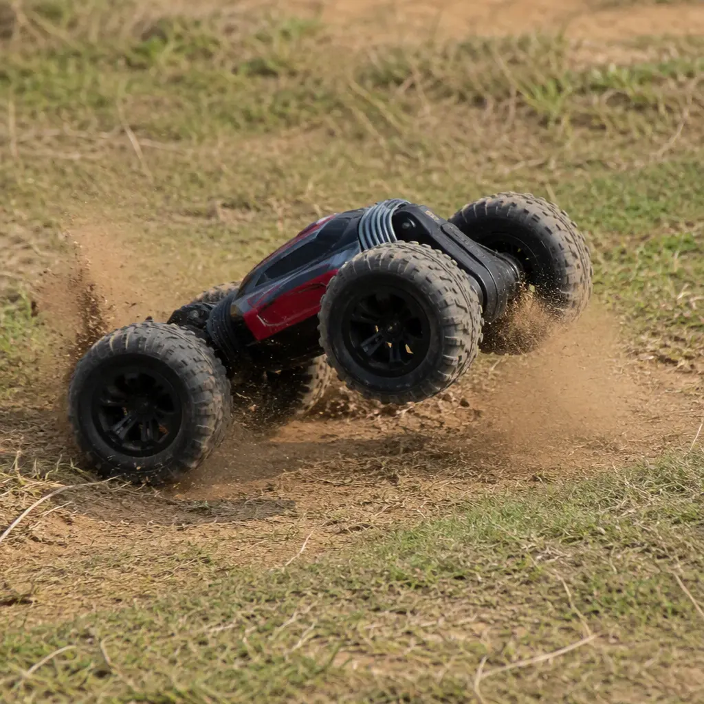A double-sided remote-control stunt car driving outdoors over dirt and grass